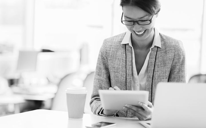 Employee working and smiling at her desk